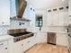 Modern kitchen design featuring stainless steel appliances, custom white cabinets, and stylish backsplash at 2614 Parkland Dr, Winter Park, FL 32789