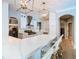 Bright kitchen with white cabinetry, stainless steel appliances, and a marble countertop bar at 2614 Parkland Dr, Winter Park, FL 32789