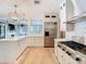 Spacious gourmet kitchen featuring stainless steel appliances and a large center island with pendant lighting at 2614 Parkland Dr, Winter Park, FL 32789