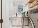 Well-organized laundry room showcasing modern machines, a countertop sink, and decorative wallpaper at 2614 Parkland Dr, Winter Park, FL 32789