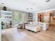 Bright living room with stylish white furniture and hardwood floors at 2614 Parkland Dr, Winter Park, FL 32789
