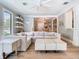 Bright living room with stylish white furniture and hardwood floors at 2614 Parkland Dr, Winter Park, FL 32789