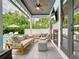 Outdoor living area features a covered patio, fireplace, and comfortable seating at 2614 Parkland Dr, Winter Park, FL 32789