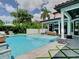 A sparkling pool and spa are adjacent to an outdoor lounge under a covered patio at 2614 Parkland Dr, Winter Park, FL 32789