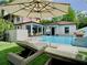 Well-maintained backyard pool and outdoor living space with lounge chairs and sun umbrella at 2614 Parkland Dr, Winter Park, FL 32789