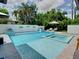 An inviting pool with a spa features a waterfall wall with decorative planters, perfect for relaxation at 2614 Parkland Dr, Winter Park, FL 32789