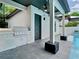 Outdoor kitchen boasts a built-in grill, adjacent to a modern poolside patio with a ceiling fan at 2614 Parkland Dr, Winter Park, FL 32789