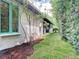 Landscaped side yard with mulched flower beds and a manicured lawn at 2614 Parkland Dr, Winter Park, FL 32789