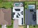 Aerial view showcasing a home with solar panels, a backyard pool, and well-manicured landscaping at 2926 Crest Wave Dr, Clermont, FL 34711