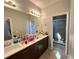 Bathroom featuring double sinks, dark wood cabinets, and glass enclosed shower at 2926 Crest Wave Dr, Clermont, FL 34711