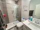 Modern bathroom showcasing a glass-enclosed shower, white vanity, and contemporary fixtures at 2926 Crest Wave Dr, Clermont, FL 34711