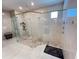 Stunning bathroom featuring frameless glass shower, dual showerheads, and elegant marble tile at 2926 Crest Wave Dr, Clermont, FL 34711