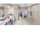 Bright bathroom featuring a vanity and a glass-enclosed shower with tiled walls at 2926 Crest Wave Dr, Clermont, FL 34711