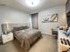 Beautiful bedroom with a king-sized bed, stylish decor, and soft gray carpet at 2926 Crest Wave Dr, Clermont, FL 34711