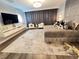 Stylish bedroom featuring plush bedding, accent lighting, and a sleek entertainment center at 2926 Crest Wave Dr, Clermont, FL 34711