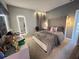 Comfortable bedroom with a soft bed, stylish mirror, and ambient lighting at 2926 Crest Wave Dr, Clermont, FL 34711