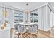 Bright dining area features a round table with gray upholstered chairs and views of the waterfront at 2926 Crest Wave Dr, Clermont, FL 34711