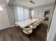 Elegant dining room with modern decor, a long white table, and stylish chairs at 2926 Crest Wave Dr, Clermont, FL 34711