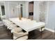 Elegant dining room with modern decor, a long white table, and stylish chairs at 2926 Crest Wave Dr, Clermont, FL 34711