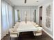 Elegant dining room with modern decor, a long white table, and stylish chairs at 2926 Crest Wave Dr, Clermont, FL 34711