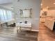 Bright foyer features stylish console table with gold accents, mirror, and views of dining area and kitchen at 2926 Crest Wave Dr, Clermont, FL 34711