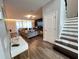 Inviting foyer with staircase and views of the living room, featuring elegant decor and hardwood floors at 2926 Crest Wave Dr, Clermont, FL 34711