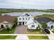 Beautiful two-story home with paver driveway and solar panels near the lake and lush landscaping at 2926 Crest Wave Dr, Clermont, FL 34711
