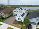 Two-story home with solar panels, paver driveway, landscaping, and beautiful views of the lake at 2926 Crest Wave Dr, Clermont, FL 34711