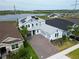 Beautiful two-story home with a paver driveway, solar panels, and well-manicured landscaping at 2926 Crest Wave Dr, Clermont, FL 34711
