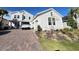 Charming two-story home with a well-maintained front yard and brick paver driveway at 2926 Crest Wave Dr, Clermont, FL 34711