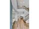 Bright foyer featuring hardwood floors, staircase, and modern lighting, flowing into an open-concept living space at 2926 Crest Wave Dr, Clermont, FL 34711