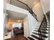 Grand foyer with hardwood floors, a soaring staircase with iron railings, and a view of the living room at 2926 Crest Wave Dr, Clermont, FL 34711