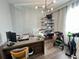 Bright home office featuring modern desk, comfortable seating, and shelving for organized workspace at 2926 Crest Wave Dr, Clermont, FL 34711