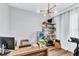 Bright home office featuring wood floors, a modern desk, and contemporary lighting perfect for productivity at 2926 Crest Wave Dr, Clermont, FL 34711