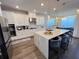 Modern kitchen features white cabinetry, a large island with seating, and stainless steel appliances at 2926 Crest Wave Dr, Clermont, FL 34711