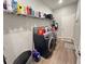 Well-organized laundry room with modern washer and dryer, shelving, and ample storage space at 2926 Crest Wave Dr, Clermont, FL 34711