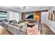 Stylish living room featuring a large sectional sofa, wood-paneled accent wall, and modern decor at 2926 Crest Wave Dr, Clermont, FL 34711