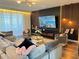 Stunning living room with a modern fireplace, custom wood accent wall, and ample seating at 2926 Crest Wave Dr, Clermont, FL 34711