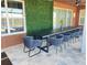 Charming outdoor patio with dining area, lush green wall, and relaxing atmosphere for enjoying serene views at 2926 Crest Wave Dr, Clermont, FL 34711
