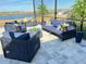 Comfortable patio seating area with modern outdoor furniture, offering a relaxing space with views of the surrounding landscape and nearby lake at 2926 Crest Wave Dr, Clermont, FL 34711