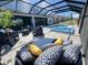 Beautiful pool area with a covered screen, comfortable seating, and a basketball hoop providing a blend of luxury and recreation at 2926 Crest Wave Dr, Clermont, FL 34711