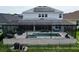 Screened-in pool and spa with outdoor seating creating a perfect outdoor relaxation and entertainment space at 2926 Crest Wave Dr, Clermont, FL 34711