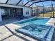 Lovely pool area with integrated hot tub, all within a screened enclosure, offering a blend of luxury and comfort for outdoor enjoyment at 2926 Crest Wave Dr, Clermont, FL 34711