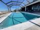 Stunning view of the pool area under a screened enclosure, offering a refreshing escape with a blend of luxury and leisure at 2926 Crest Wave Dr, Clermont, FL 34711