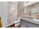Modern powder room with patterned wallpaper, unique marble sink, and stylish vanity offering a luxurious touch at 2926 Crest Wave Dr, Clermont, FL 34711