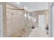 A spacious shower with a frameless glass enclosure, tiled walls, and dual shower heads at 2926 Crest Wave Dr, Clermont, FL 34711