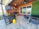 Outdoor summer kitchen with bar seating, built-in grill, and stylish pendant lighting for alfresco dining at 2926 Crest Wave Dr, Clermont, FL 34711
