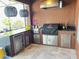 Well-equipped outdoor kitchen featuring built-in appliances and grill, perfect for summer entertaining and barbecues at 2926 Crest Wave Dr, Clermont, FL 34711