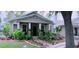 Charming single-story home with a cozy front porch and lush, colorful garden at 312 N Forest Ave, Orlando, FL 32803