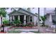 Cozy single-story home featuring a quaint front yard with vibrant landscaping and a welcoming porch at 312 N Forest Ave, Orlando, FL 32803